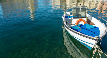 Fototapeta na wymiar Small boat stops at the port