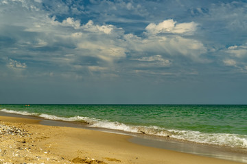 Sea view from tropical beach with sunny sky.
