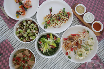 Various healthy fish and vegetables meals served on the table, healthy summer lunch