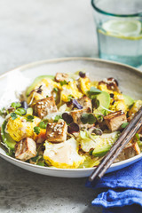 Fried tofu, cauliflower and avocado salad with sprouts. Vegan healthy food concept.