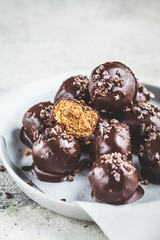 Vegan Chocolate Truffle Balls with peanut butter on gray plate.