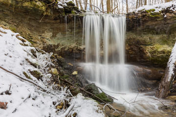 Obraz premium City Sigulda, Latvia. Waterfall in winter. White snow and trees. Travel photo.