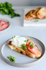 Toast with salmon, poached egg and basil. Morning and Breakfast. Healthy nutrition. Selective focus