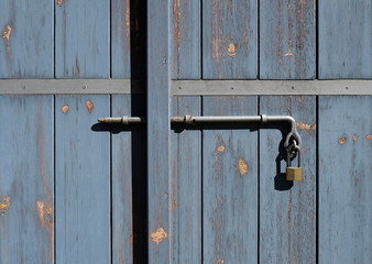 Metal lock on weathered wooden door