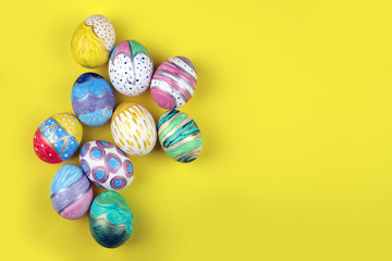 painted handmade easter eggs on a yellow background