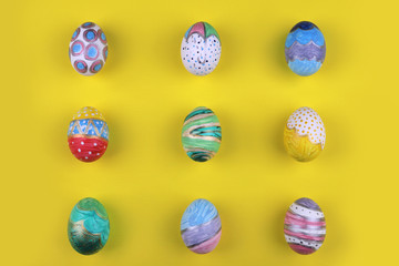 painted handmade easter eggs on a yellow background