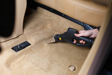 Professional cleaning a car floor