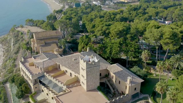 Aerial view of a traditional hermitage in front of Mediterranean Sea. Shrine name is Mare de Deu de Bara (God's Mother of Bara) and it's located near Roc de Sant Gaieta, Tarragona province Spain