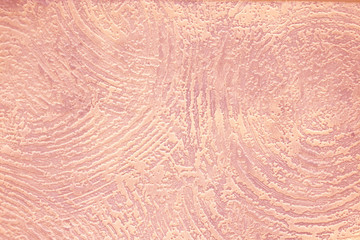 Texture of light red wall with uneven painting in the form of abstract circles