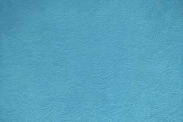 Blue wall painted with rough brush strokes, background