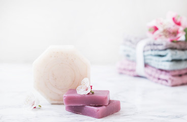 natural soap. handmade soap. Stack of fresh towels with flowers on white background. spa treatments