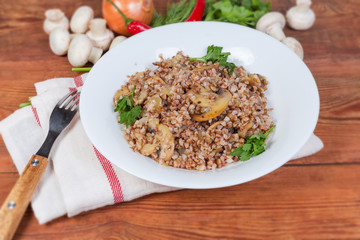 Buckwheat porridge with fried mushrooms and ingredients close-up