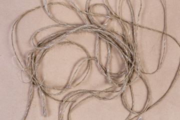 Background of unwound twine on a cardboard surface, fragment, texture
