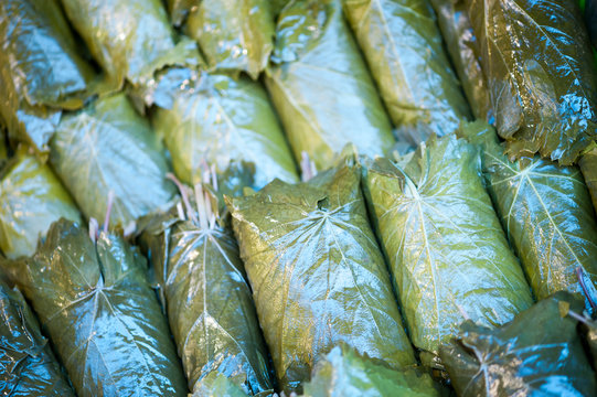 Stack of authentic Mediterranean stuffed grape vine leaves at an outdoor market in Istanbul, Turkey
