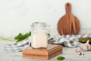 Jar of tasty sauce on white table