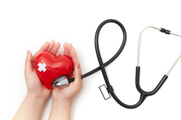 Red heart and stethoscope in both hands