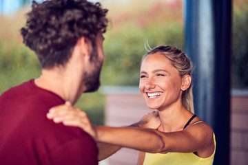 Modern couple doing exercise in urban area.