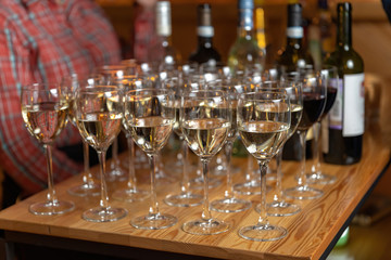Glasses of red and white wine on the table, warm yellow light-2.