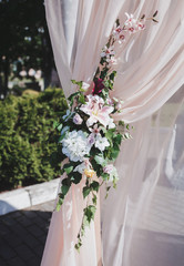 Arch for the wedding ceremony. Arch decorated and silvery cloth and flowers