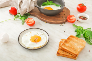 Fried egg with toasted bread on white background