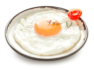 Plate with fried egg on white background