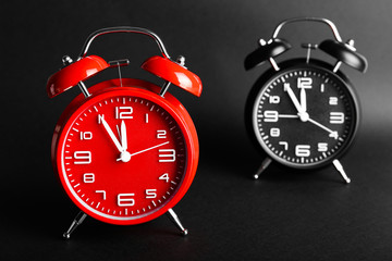 Alarm clocks on dark background. Time management concept