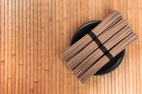 Buckwheat noodles closeup. Raw food ingredient. Dried buckwheat soba noodles. Traditional Japanese food - Image