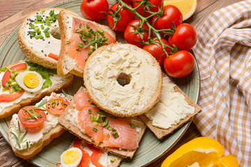 Different sandwiches with tasty cream cheese on plate