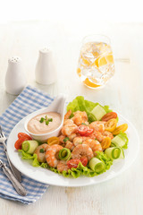 Grilled shrimp salad with fresh lettuce, cherry tomatoes and creamy sauce.