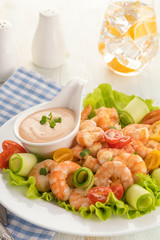 Grilled shrimp salad with fresh lettuce, cherry tomatoes and creamy sauce.