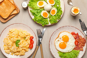 Different tasty dishes with eggs on table