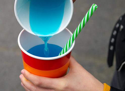 Woman Pouring Soda From One Glass To Another Glass At A Party.