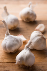 A lot of garlic on a wooden background. Close-up
