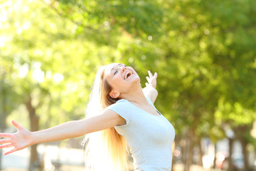 Happy teenage girl stretching arms celebrating new day