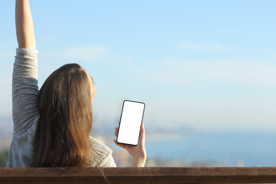 Excited Woman Showing Blank Phone Screen Raising Arms