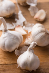 A lot of garlic on a wooden background, top view. Background for design