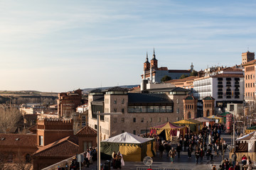 TERUEL, SPAIN - FEBRUARY 22 2020: Medieval festival of Bodas de Isabel de Segura recreating the legend of the Lovers of Teruel, market stall, the beautiful city and seminar at the background