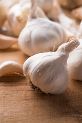 A lot of garlic on a wooden background. Close-up
