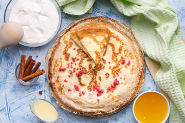 Delicious Russian pancakes with sour cream and honey cooked for Shrovetide celebration