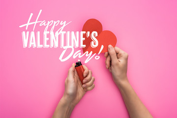 cropped view of woman lighting up empty red paper heart with lighter isolated on pink with happy valentines day illustration