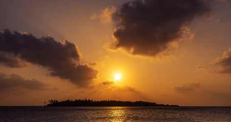 dramatic sunset sky above a tropical island in Maldives