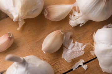 A lot of garlic on a wooden background. Close up, horizontal photo