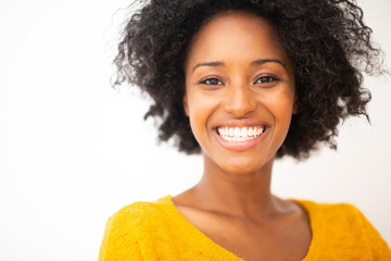 Close up beautiful young african american woman smiling against white isolated background