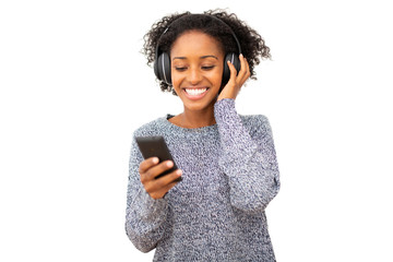 smiling young black woman with mobile phone and headphones listening to music  against isolated white background
