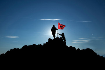 Two soldiers raise the Albanian flag