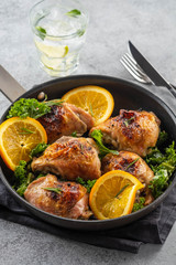 Chicken thighs with orange is a pan.