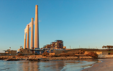 Obraz premium The power plant on the Mediterranean coast at sunset