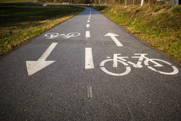 Bicycle path, two way cycling track with bicycle signs painted white