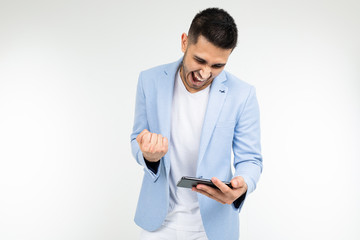 portrait of a man with a phone in his hands playing games on a white background