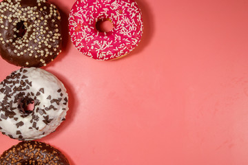 Tasty donuts on pink background. Top view, copy space